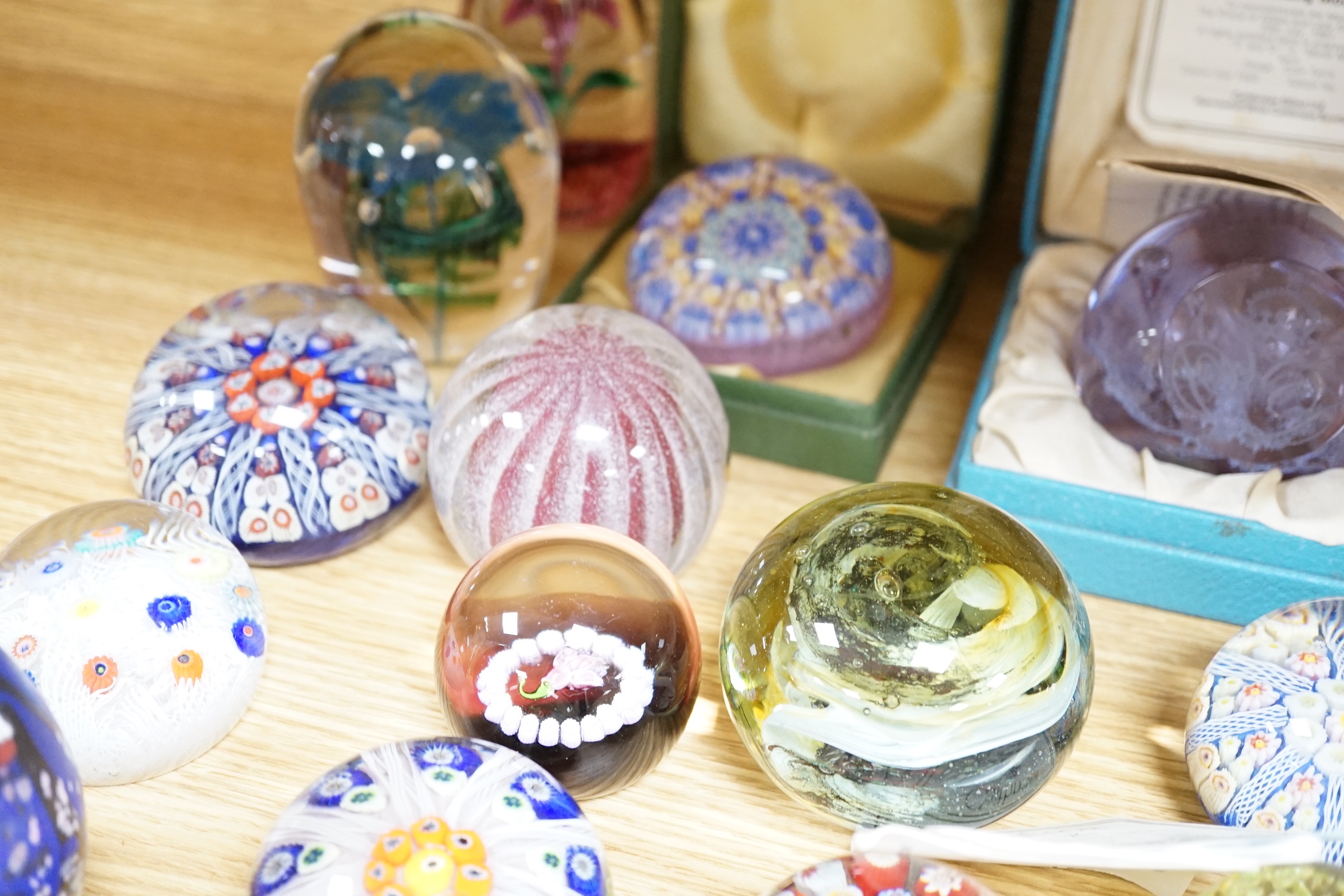 A collection of coloured glass paperweights including Strathearn, Caithness (28)